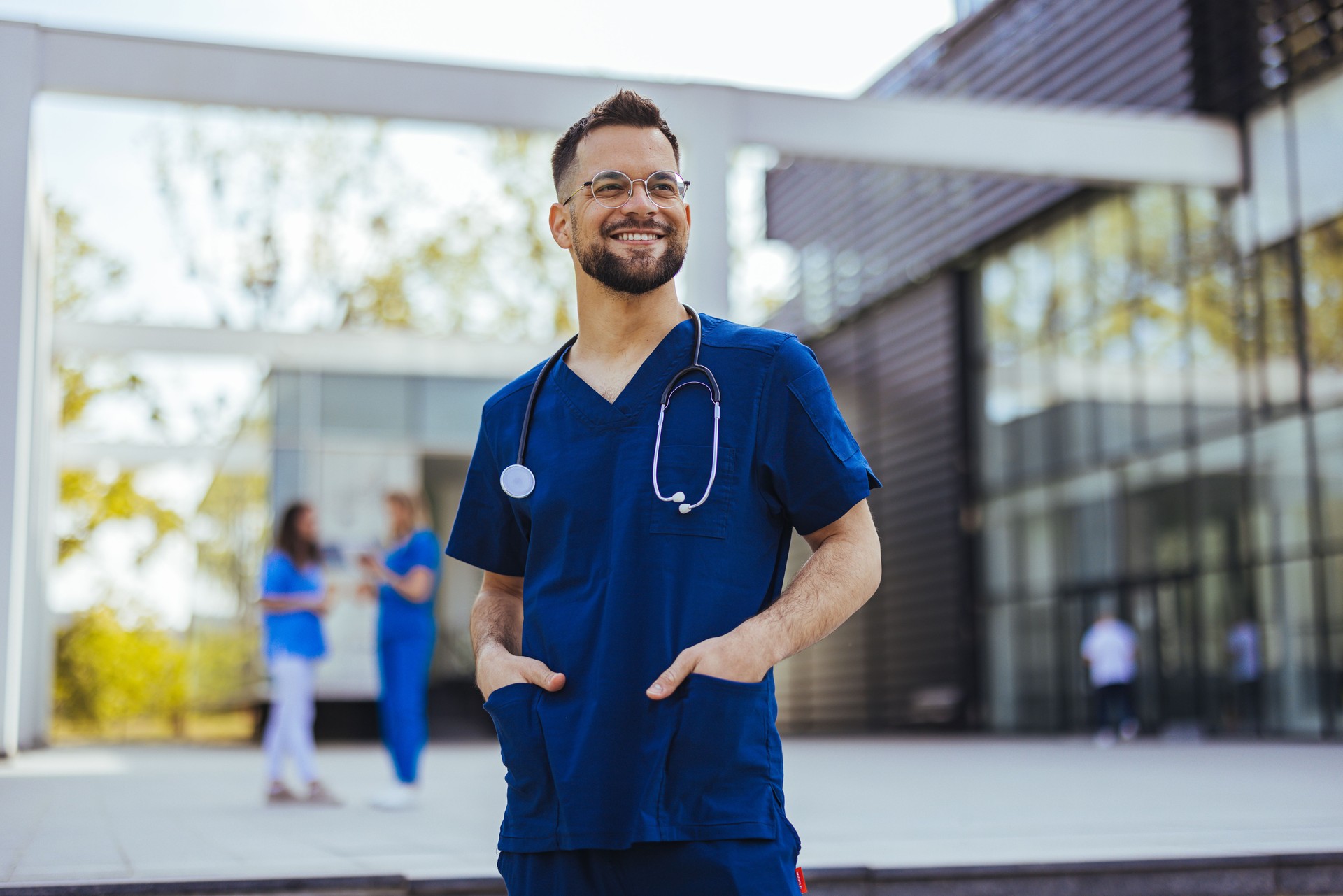 Portrait of a young medical practitioner standing with his arms crossed in a hospital.